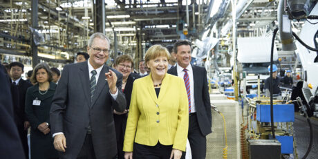 Albert Kirchmann (left) shows Mitsubishi Fuso Truck and Bus Corp.’s Kawasaki factory to German Chancellor Angela Merkel in March 2015. | Albert Kirchmann (left) shows Mitsubishi Fuso Truck and Bus Corp.'s Kawasaki factory to German Chancellor Angela Merkel in March 2015. Albert Kirchmann (left) shows Mitsubishi Fuso Truck and Bus Corp.’s Kawasaki factory to German Chancellor Angela Merkel in March 2015. | Albert Kirchmann (left) shows Mitsubishi Fuso Truck and Bus Corp.'s Kawasaki factory to German Chancellor Angela Merkel in March 2015.